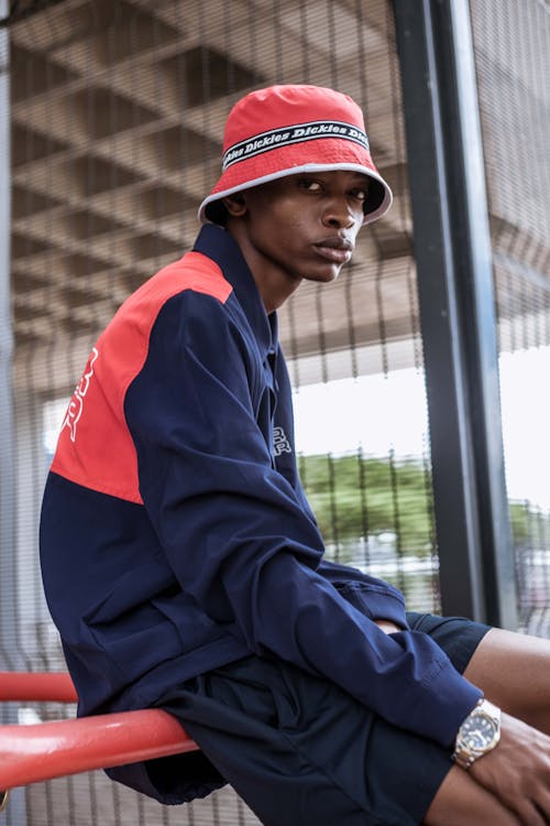 Man in Red Fitted Cap and Blue Jacket