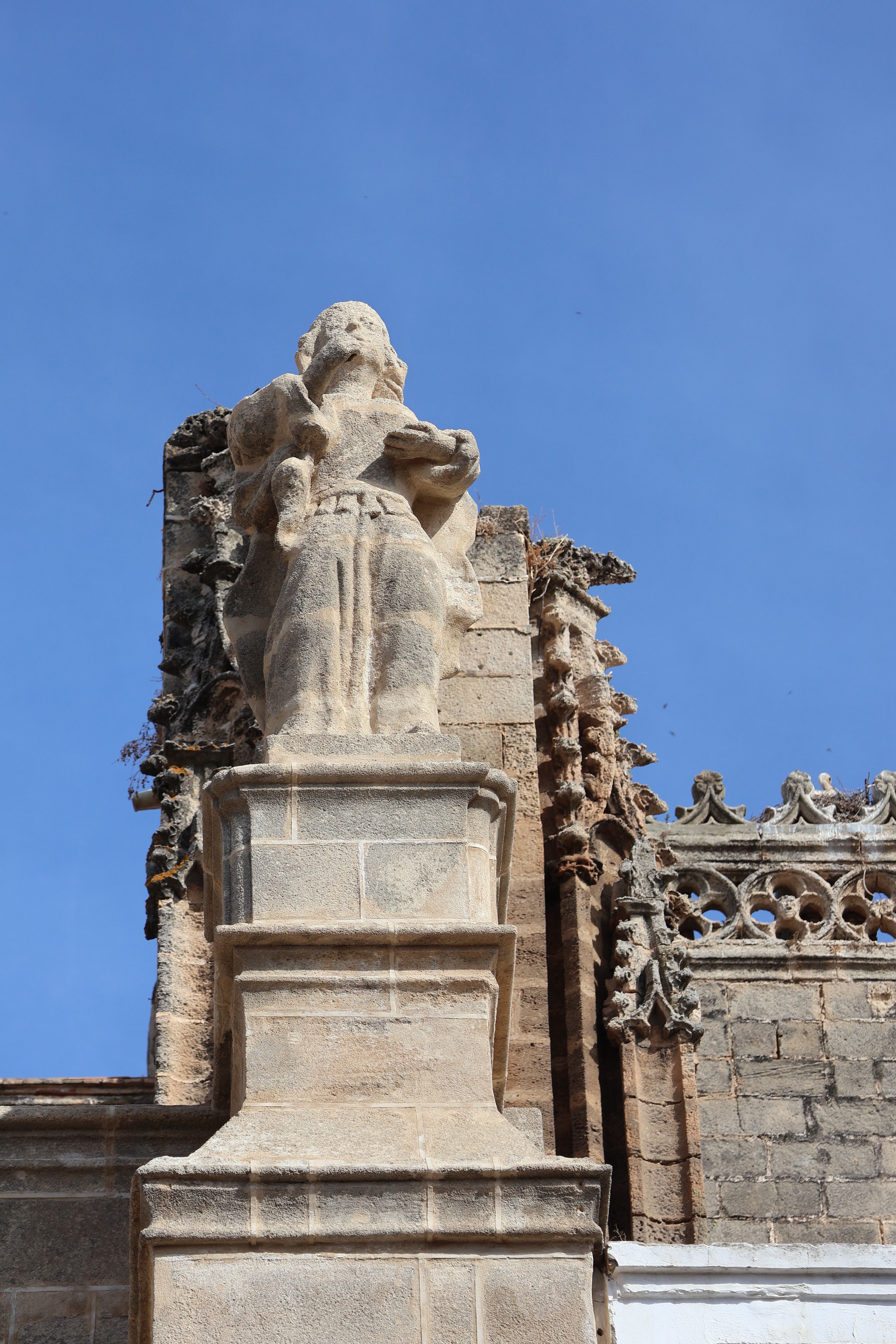 A stunning Gothic sculpture detail on a historic church facade in El Puerto de Santa María, Spain.
