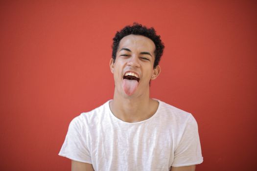 Man in White Crew Neck T-shirt Sticking his Tongue out