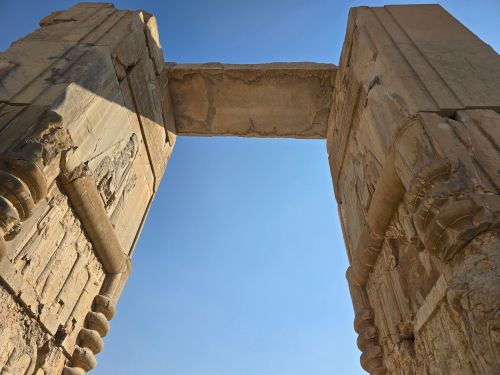 Free View of ancient stone ruins at Persepolis, Iran under clear blue sky. Stock Photo