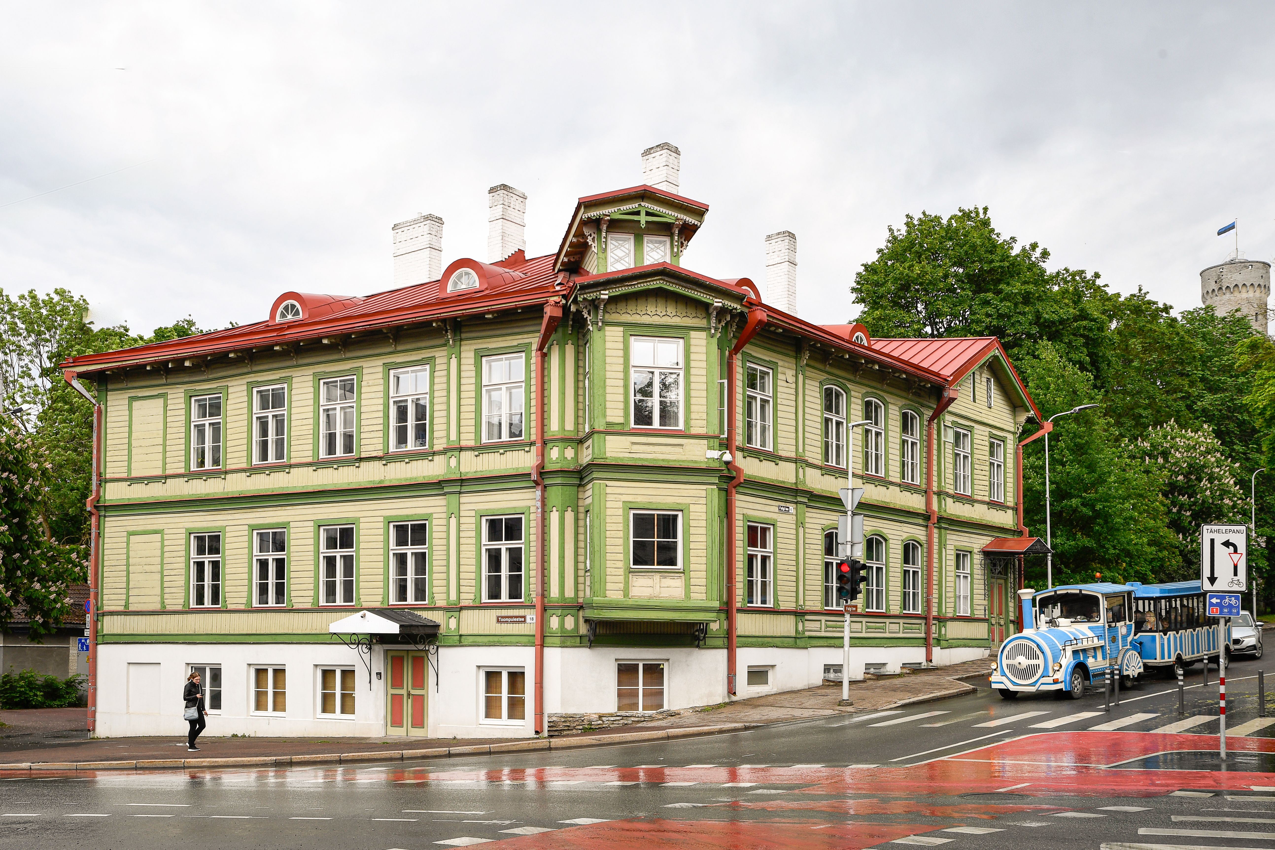 A guided walking tour group exploring the historic Town Hall Square in Tallinn's Old Town, Estonia.