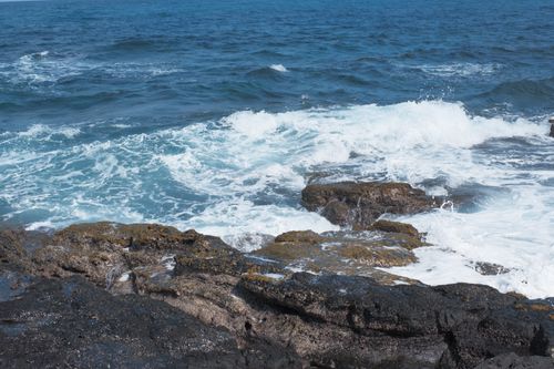 Free Dramatic ocean waves crashing onto rocky coastline, showcasing nature's power and beauty. Stock Photo
