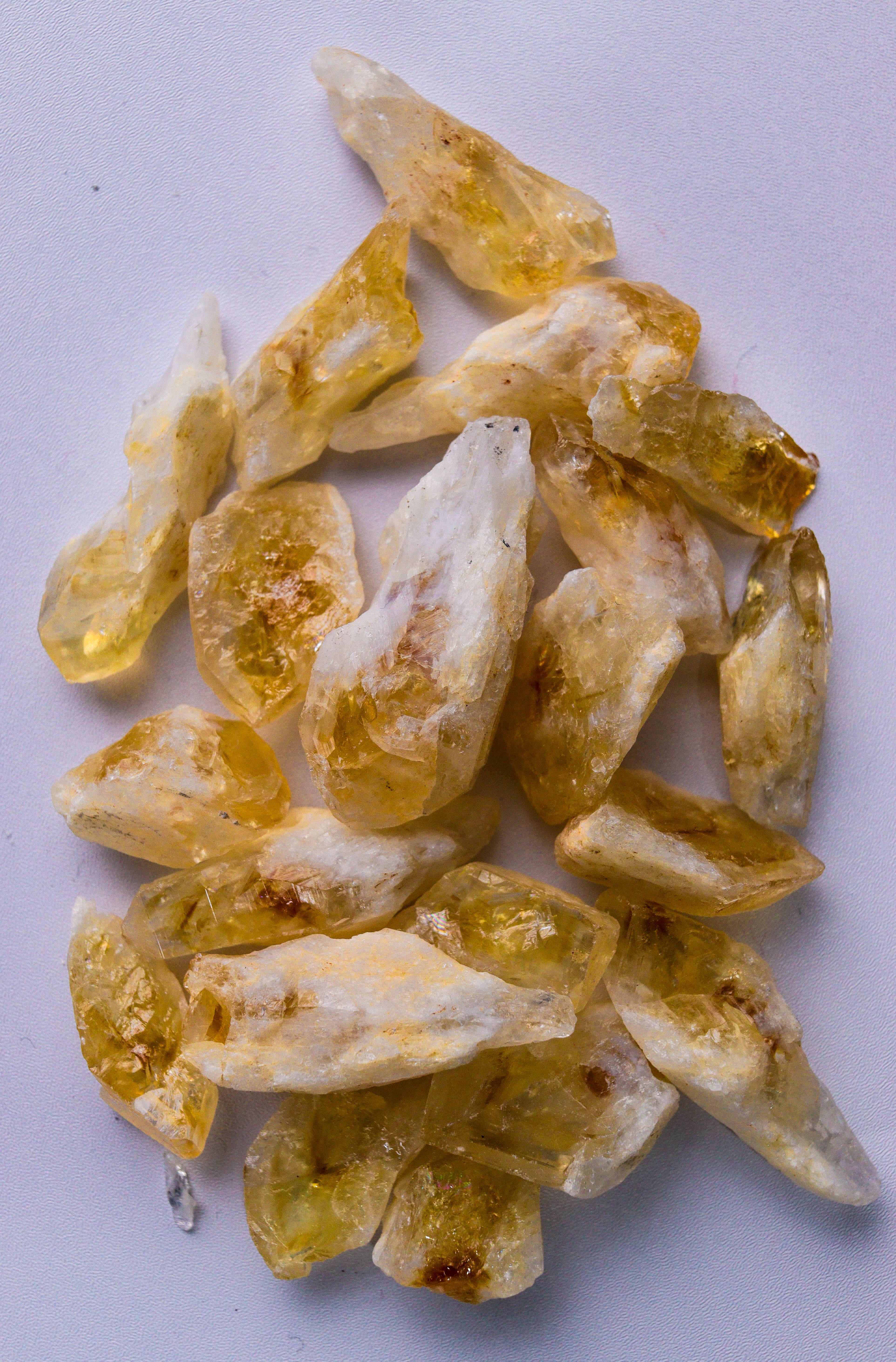 High-quality image of raw citrine crystals isolated on a white surface.