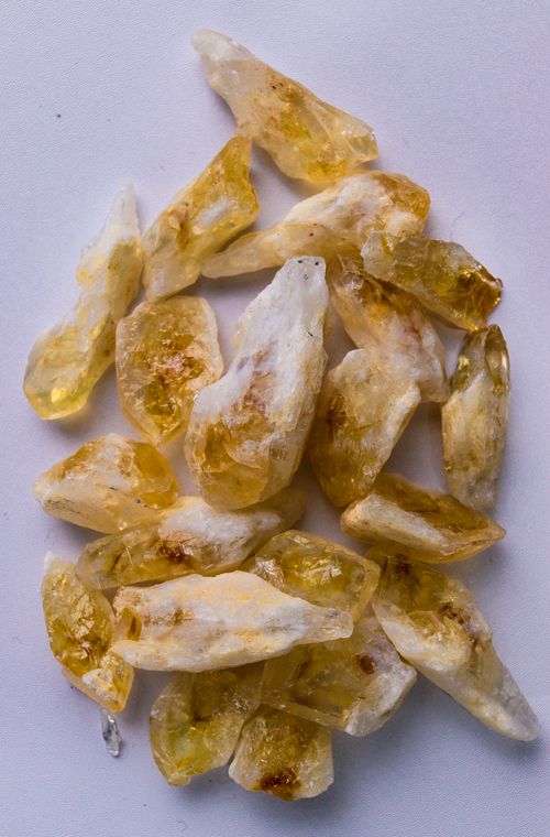 Free High-quality image of raw citrine crystals isolated on a white surface. Stock Photo