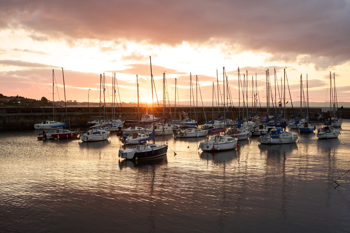 Moored boats in a harbour at sunset, photo by Valentine Kulikov on Pexels