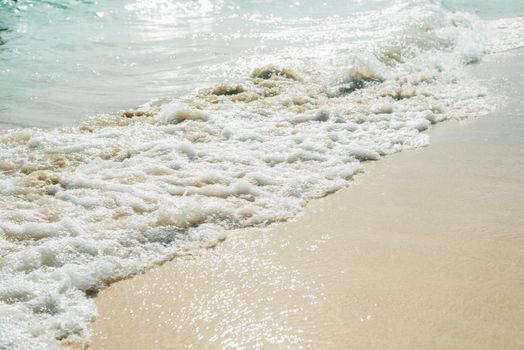 Peaceful beach scene with rolling waves and soft sand, perfect for relaxation and summer vibes.