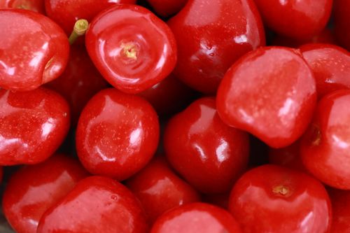 Free Vibrant close-up of glossy, ripe red cherries, perfect for food and summer themes. Stock Photo