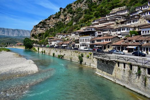 Charming view of Berat, Albania showcasing traditional architecture alongside the Osum River and scenic mountains.