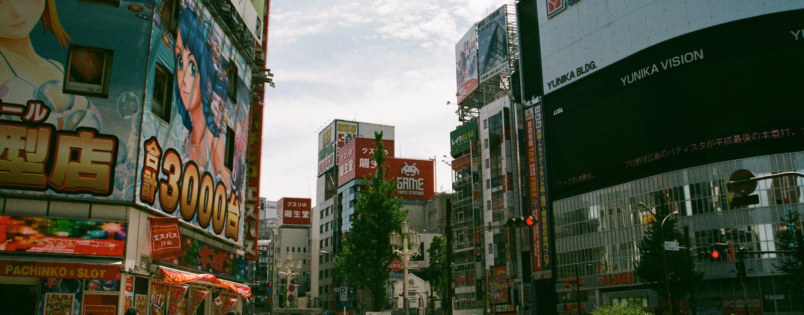 Bustling urban street in Shinjuku, Tokyo showcasing Japanese culture and vibrant billboards.