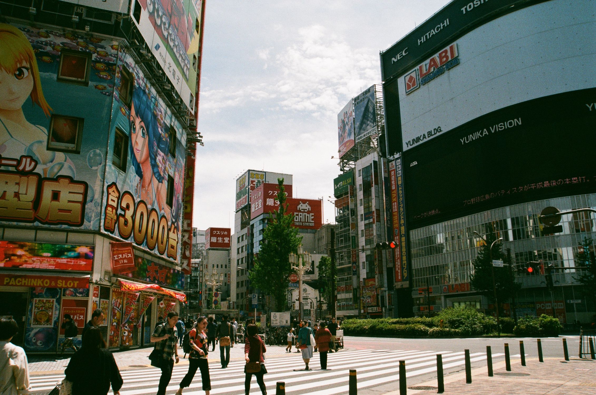 Bustling urban street in Shinjuku, Tokyo showcasing Japanese culture and vibrant billboards
