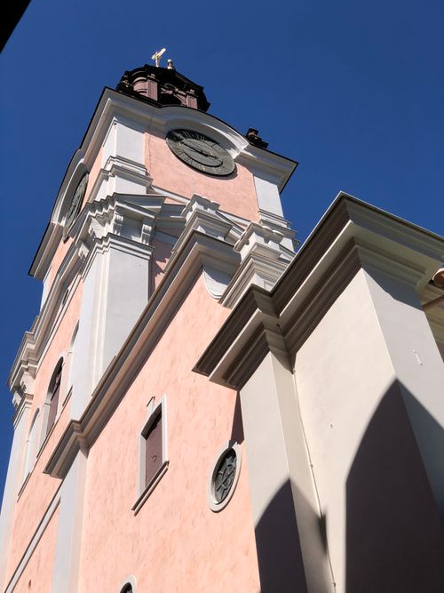Free Stunning view of an ornate church tower reaching into a vivid blue sky, highlighting classic architectural features. Stock Photo