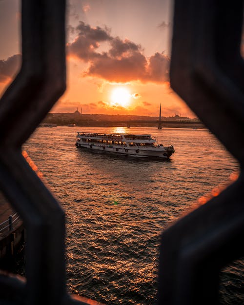 Free A Ferry Sailing on Sea during Sunset Stock Photo