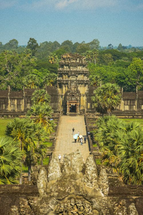Free A stunning aerial shot of the iconic Angkor Wat temple surrounded by lush greenery in Krong Siem Reap, Cambodia. Stock Photo