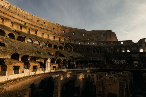 Free Explore the ancient architecture of the Roman Colosseum, captured in warm and dramatic lighting. Stock Photo