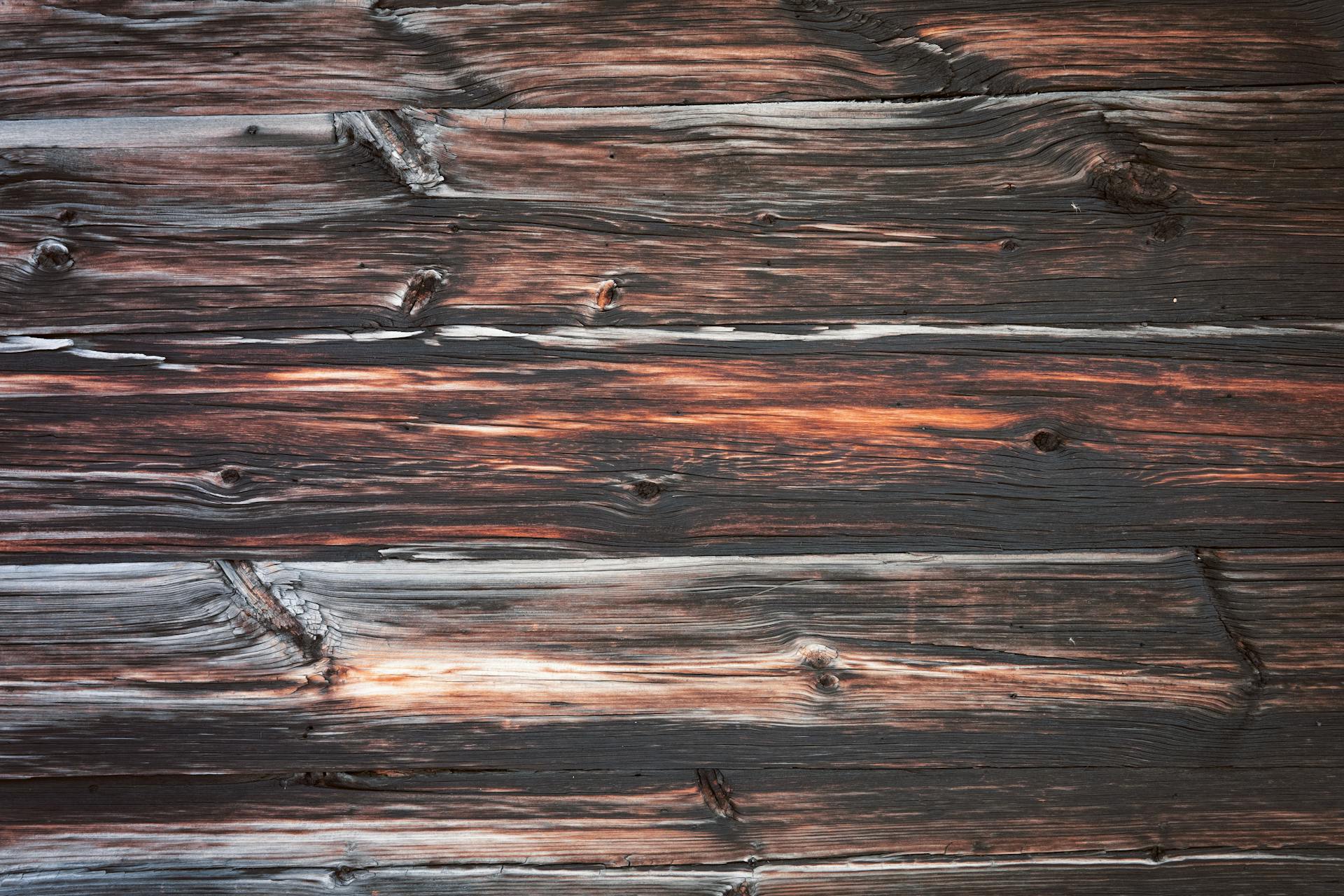 Top view of wooden surface consisting of boards with different ornament and spots and colors arranged near to each other