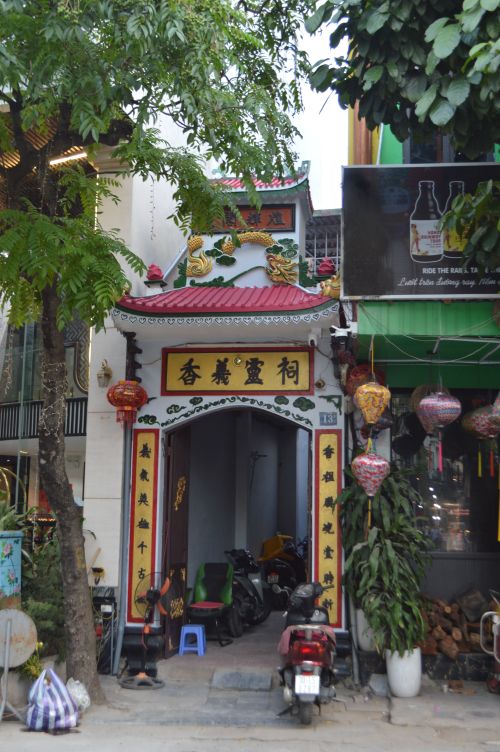 Free Traditional Asian temple facade on a vibrant street with decorative lanterns. Stock Photo