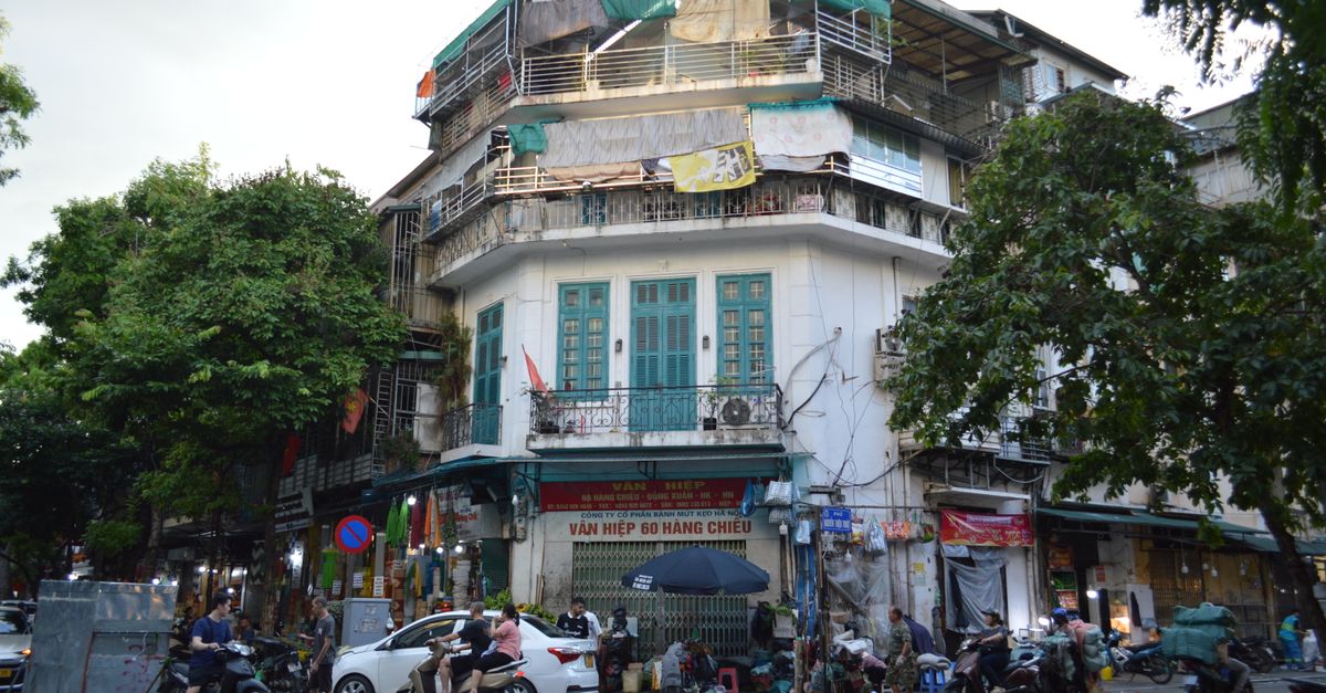 Motorbikes and shopfronts on a street in Hanoi's Old Quarter.