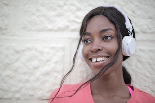 Cheerful black woman listening to music