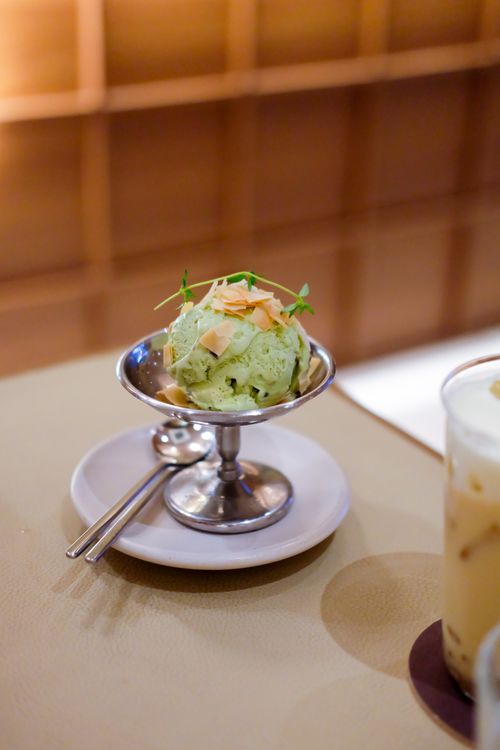 Free Green tea ice cream with delicate toppings served in a chic metal dish, perfect for dessert lovers. Stock Photo