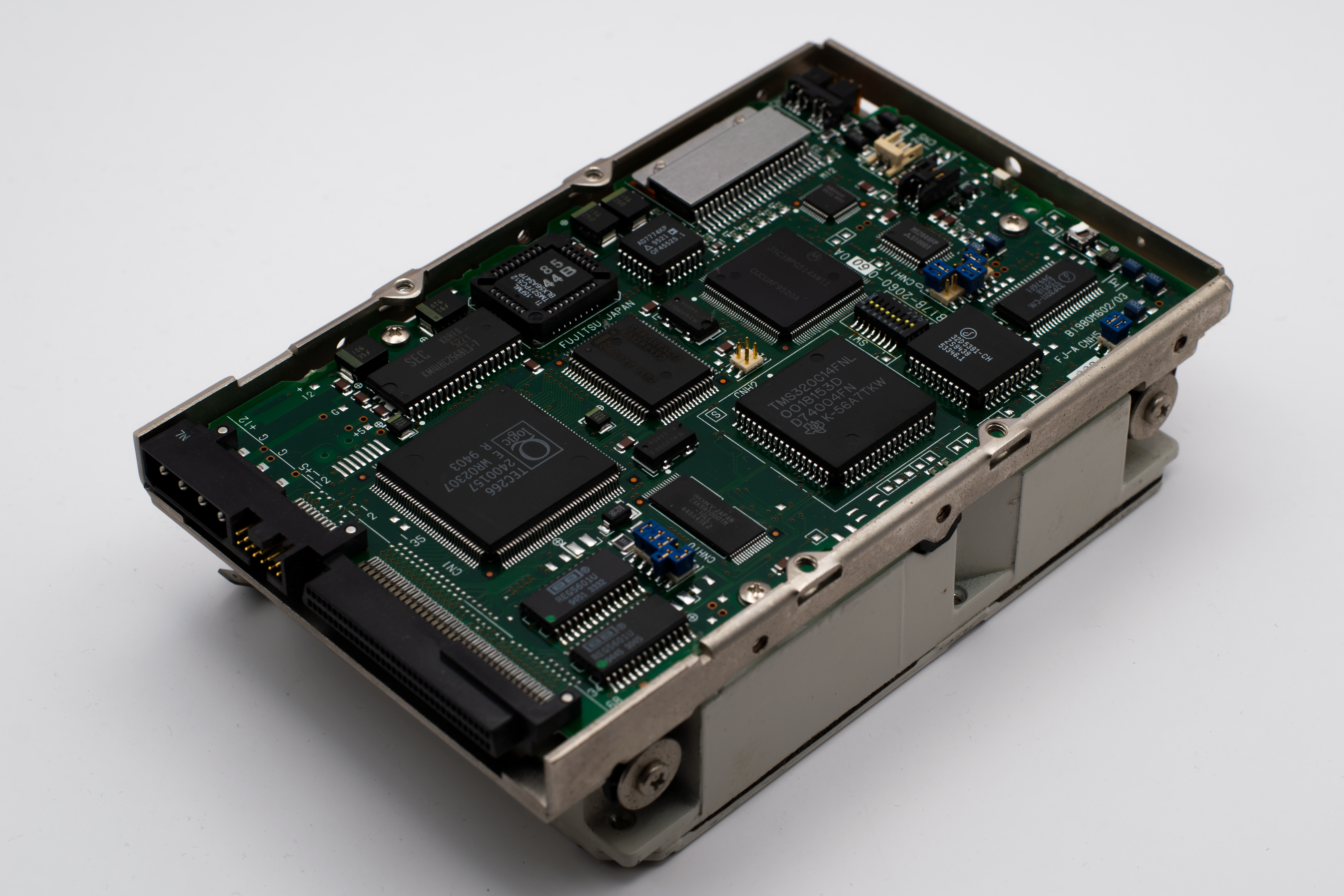 Close-up image of a vintage circuit board displaying microchips and electronic components.