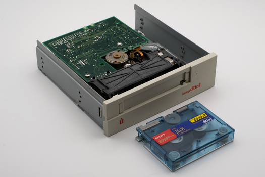 Close-up of a vintage Iomega Ditto internal tape drive with a blue Sony data cartridge, ideal for retro technology themes.