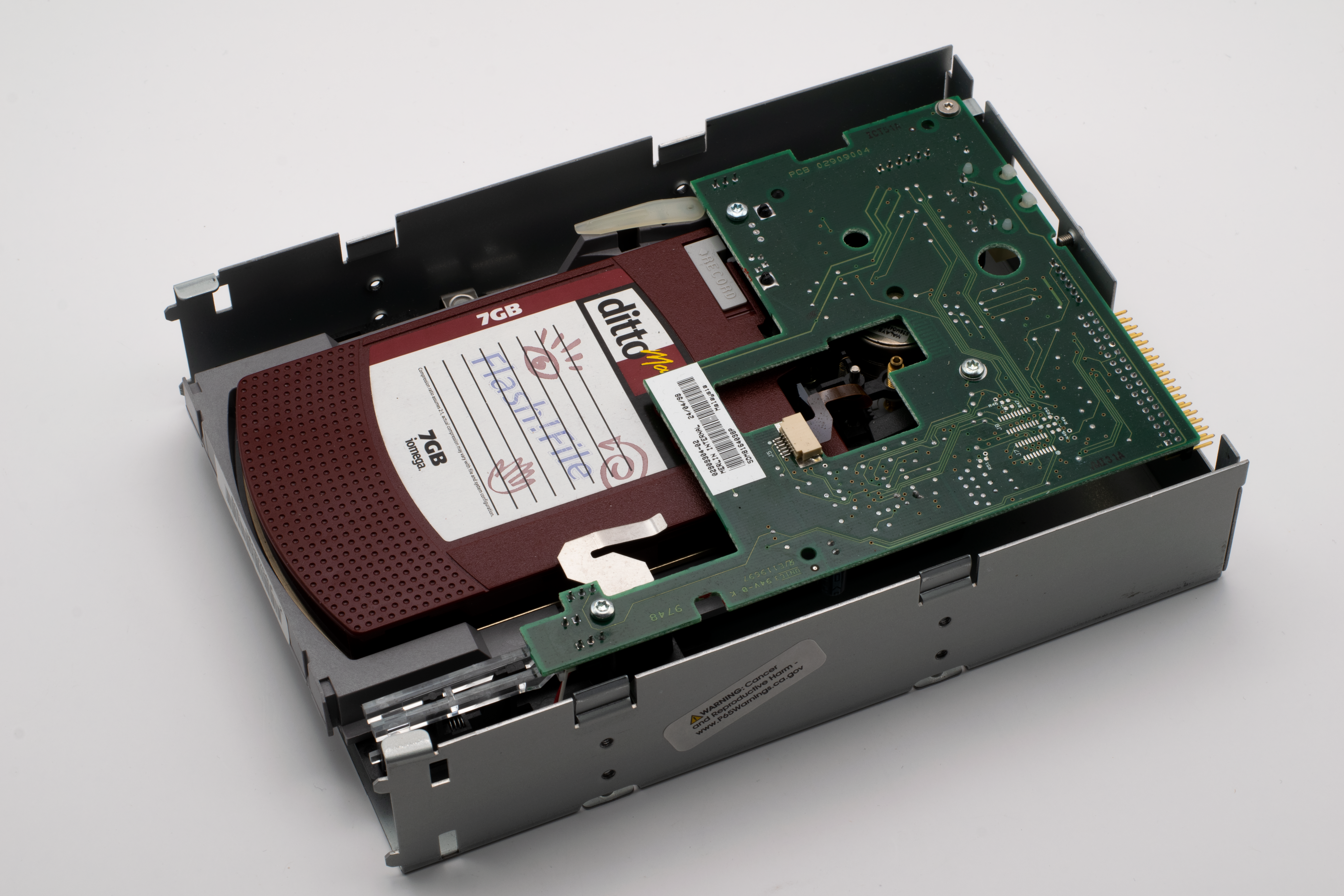 Close-up of a vintage 7GB storage drive showing intricate circuit design.