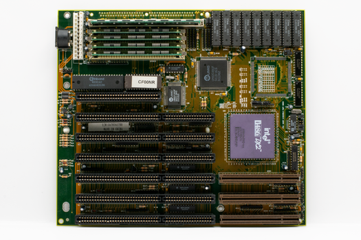 High-resolution image of a vintage computer motherboard showcasing Intel chip and circuitry.
