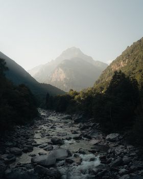 Tranquil view of river and mountains in Ticino, Switzerland, during daytime.