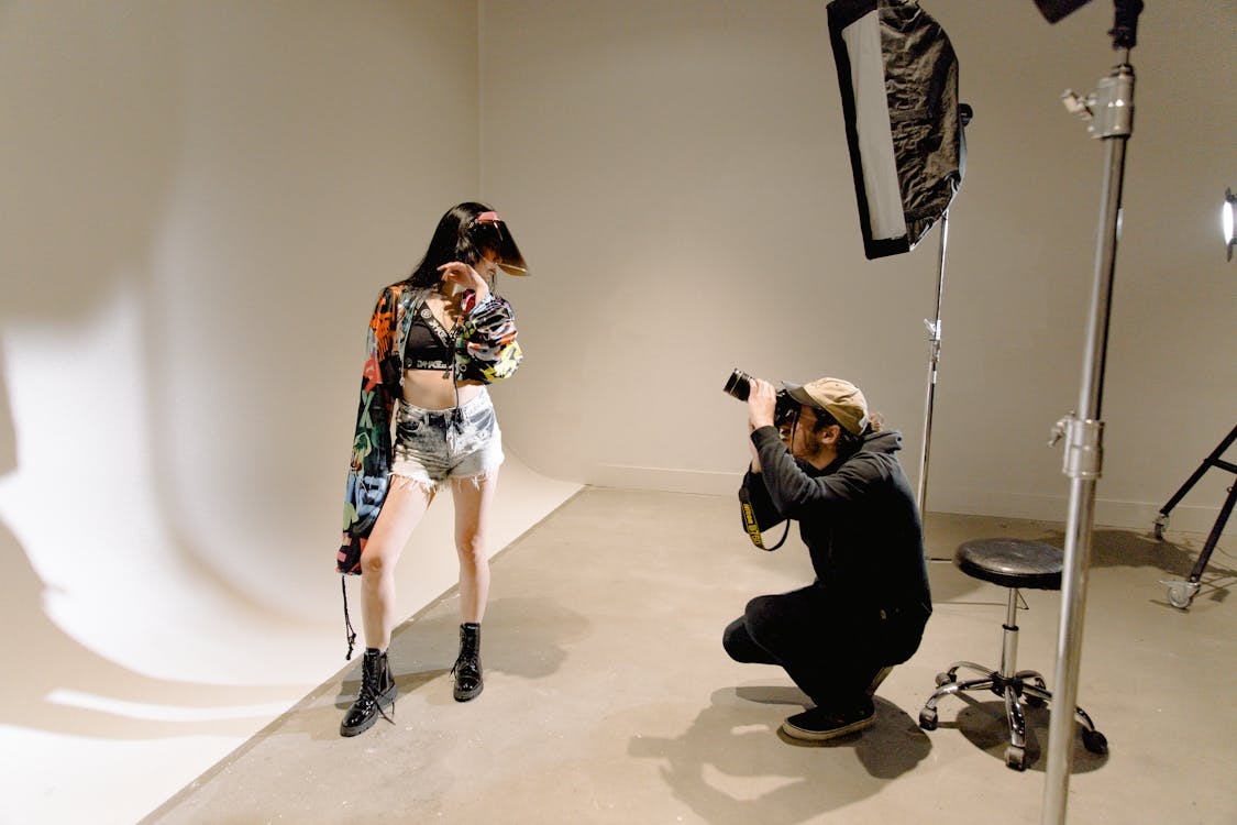 Photographer takes a photo of a fashion model during a photo shoot