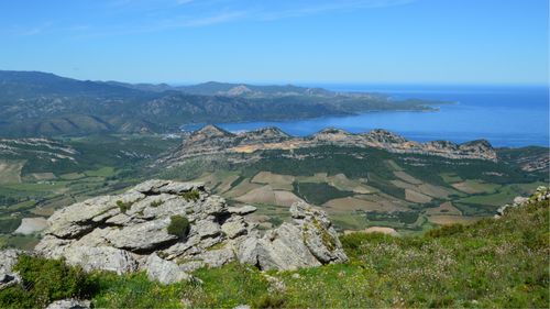 Free Breathtaking vista of Corsican mountains and coastline on a sunny day. Stock Photo