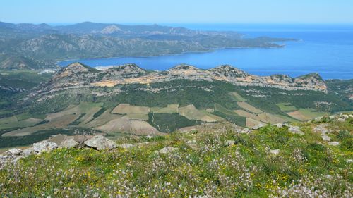 Free A breathtaking view of mountains and coastline under a clear summer sky. Stock Photo