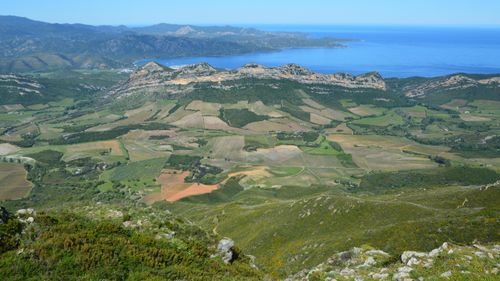 Free A stunning aerial view of a rural landscape with coastline and mountains. Perfect for nature lovers. Stock Photo