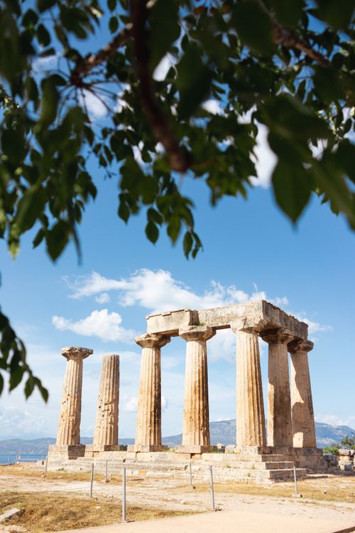 Free Explore the majestic ancient Greek temple ruins in Corinth, surrounded by a vibrant blue sky. Stock Photo