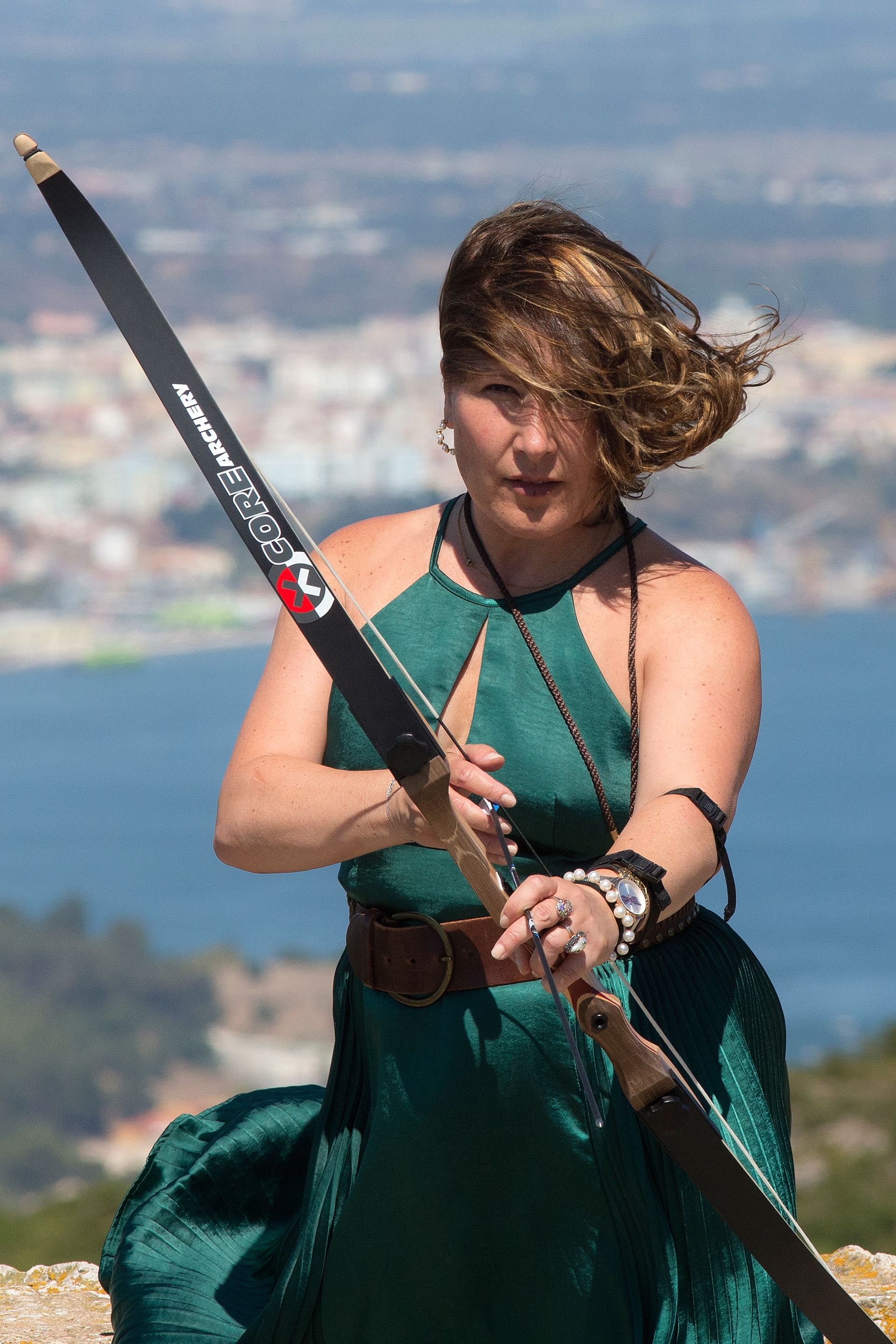 Woman Practicing Archery in Scenic Setting