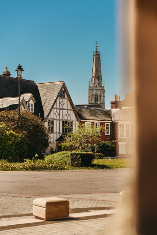 Free Charming historic buildings with a church tower in Gloucester, England under a clear blue sky. Stock Photo