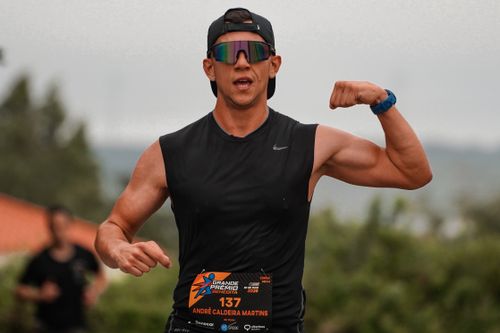 Free Runner flexes muscles triumphantly during an outdoor marathon event. Stock Photo