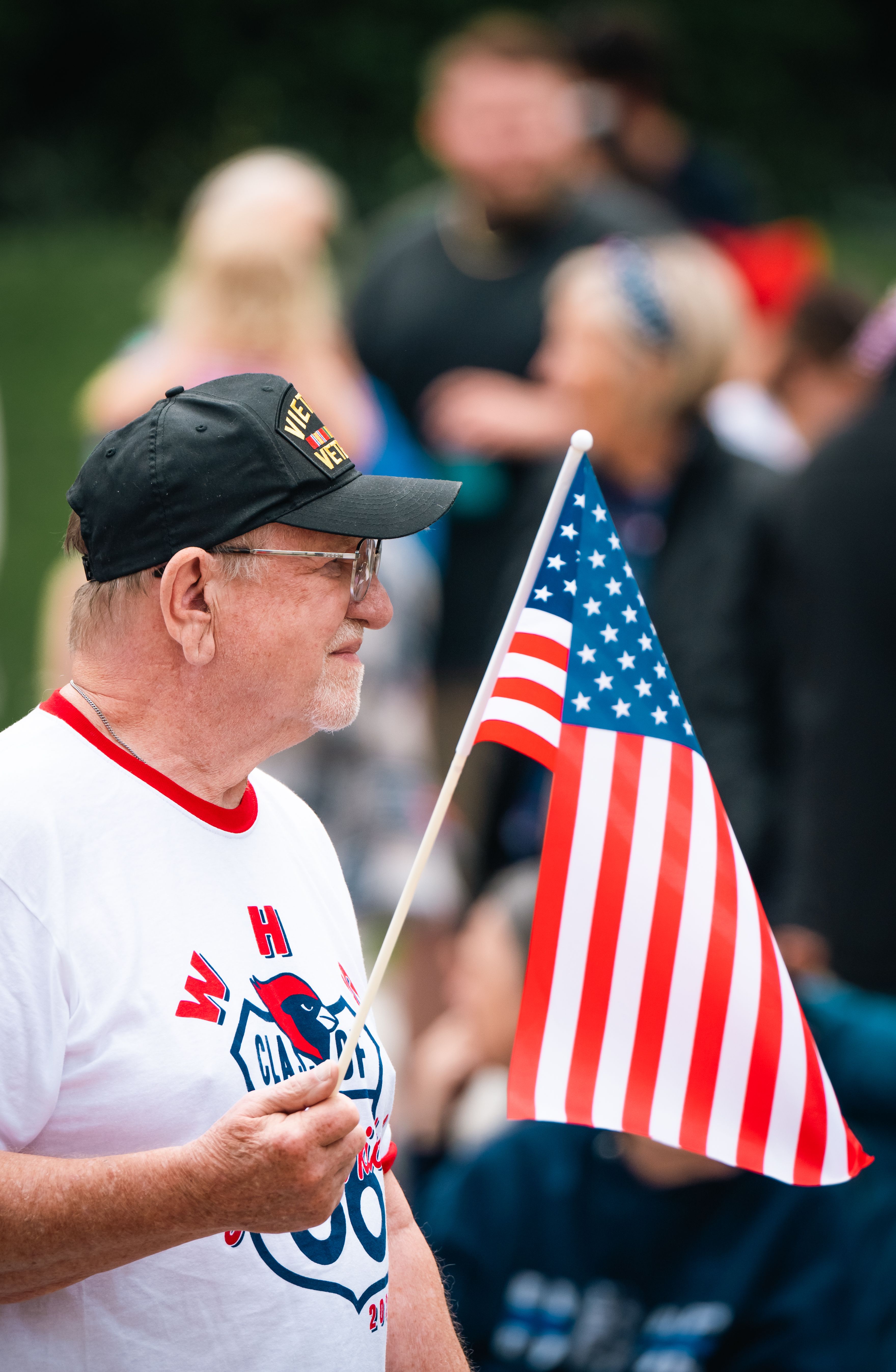 Veteran holding an American flag at an outdoor event