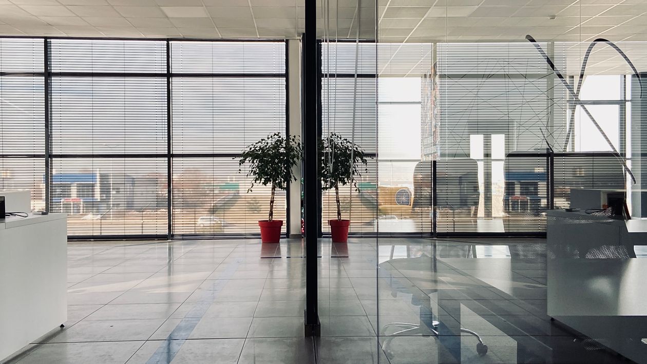 Spacious modern office with glass partitions and large windows