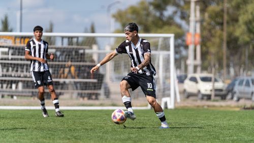 Free Two soccer players in action during a daytime match on a grassy field. Stock Photo