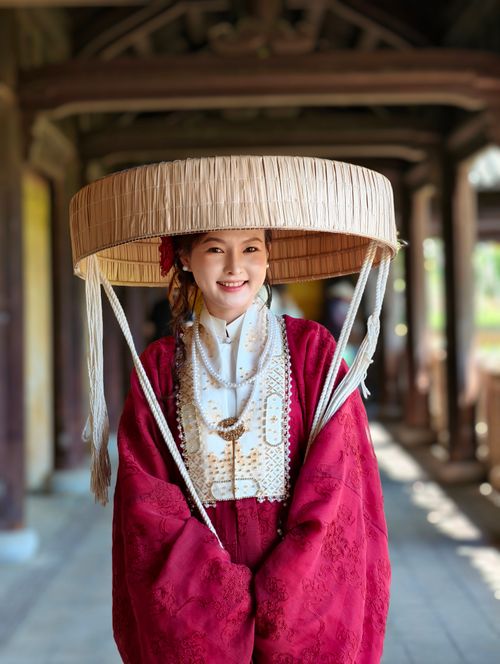 Free A woman in traditional Vietnamese bridal attire at a temple in Da Nang, Vietnam, showcasing cultural heritage. Stock Photo