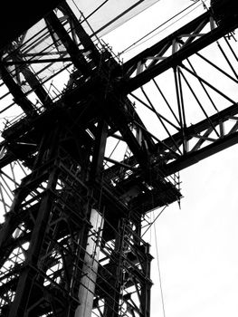 Dramatic black and white close-up of industrial steel framework, showcasing structural complexity and geometric design.