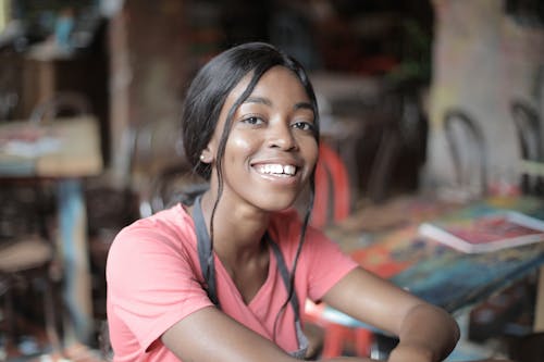 Mulher Com Camiseta Vermelha Com Gola Redonda Sorrindo