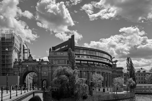 Monochrome view of a historic building with dramatic clouds in the sky.