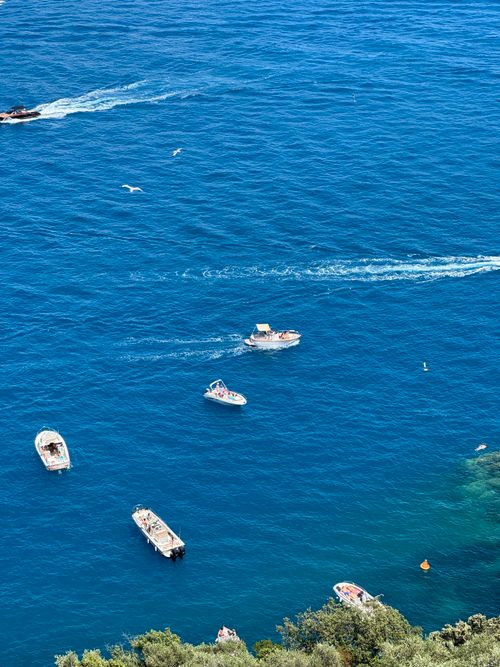 Free Scenic aerial view of boats navigating the vibrant blue waters of the Ligurian Sea near Portofino, Italy. Stock Photo