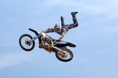 Man Riding Orange Motocross Dirt Bike