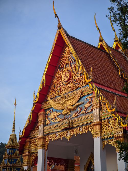 Free Detailed view of a colorful Buddhist temple facade in Phuket, Thailand showcasing ornate Thai architecture. Stock Photo