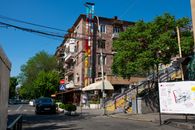 Vibrant urban street view in Yerevan featuring colorful building murals and lively atmosphere.