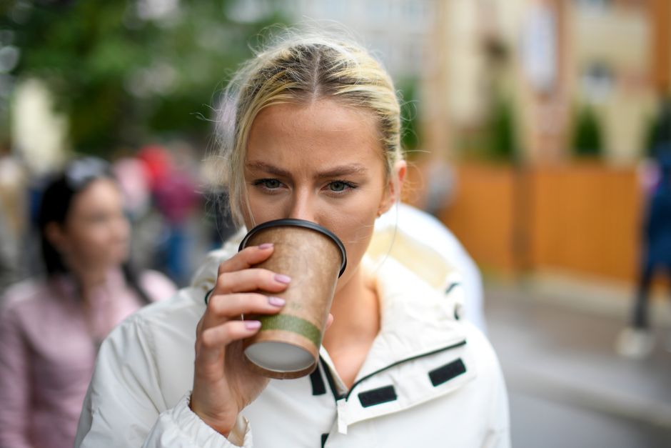 A steaming cappuccino on a table in a stylish cafe in Tallinn, Estonia