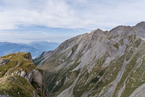 Free Breathtaking view of the rugged mountain peaks in the Swiss Alps with a grassy ridge leading into the distance. Stock Photo