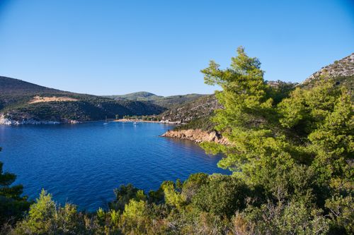 Free Explore the serene beauty of Greece's coastline with lush greenery and blue waters. Stock Photo